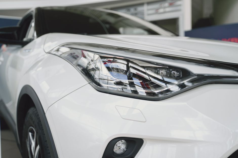 Detailed focused image of a sleek modern car headlight featuring elegant design and cutting-edge technology.