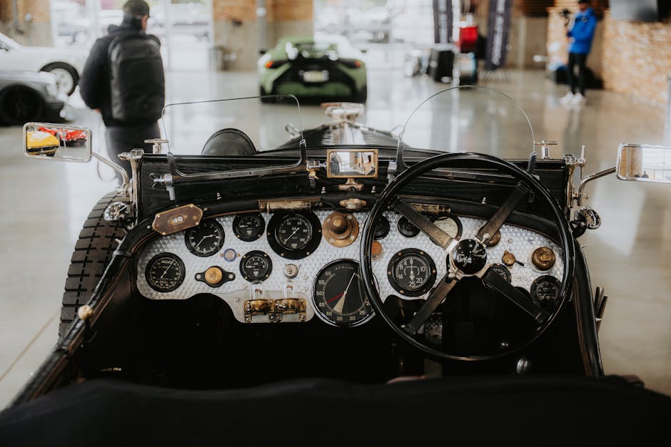 Interior view of a vintage car showing detailed dashboard and steering wheel.